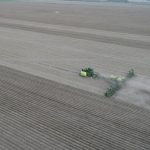 Planter machine on open crop field