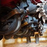 Detailed view of seed disc openers on a red planter during maintenance