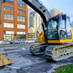 Excavator equipped with rubber track pads at a construction site